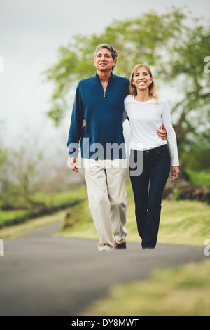 L'amour heureux couple d'âge moyen de marcher sur de belles routes de campagne Banque D'Images