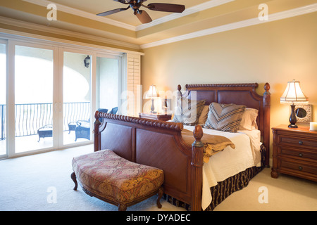 Chambre principale de luxe avec portes coulissantes en verre donnant sur balcon, USA Banque D'Images