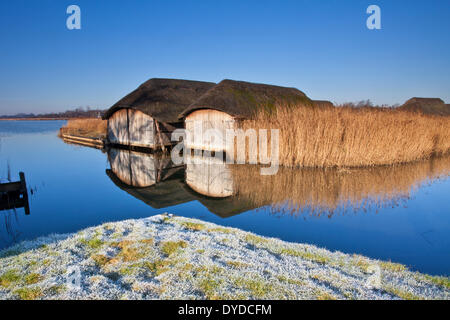 Les hangars à bateaux au large sur un Hickling matin d'hiver glacial. Banque D'Images