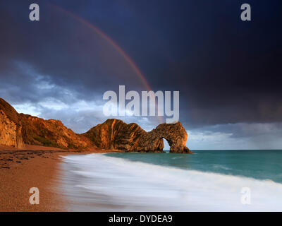 Un arc-en-ciel sur Durdle Door dans le Dorset. Banque D'Images