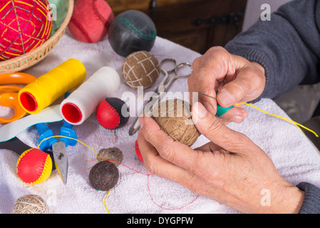 Les mains d'hommes traditionnels couture boules jai alai Banque D'Images
