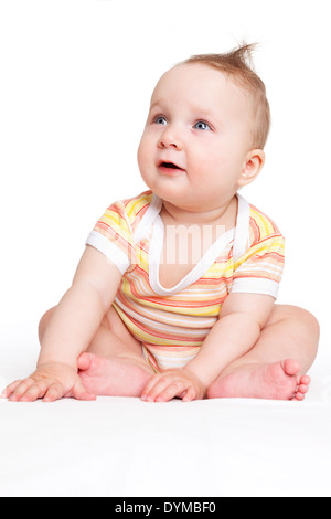 Cute baby girl sitting and looking up isolé sur fond blanc. Concept de famille heureuse. Banque D'Images