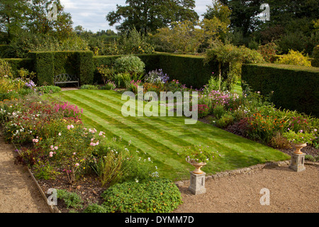 Jardin anglais formel, avec pelouse entourée de plantes été Pensionnaires Banque D'Images