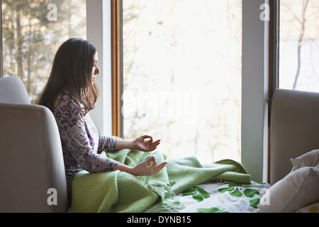 Caucasian woman sitting on sofa Banque D'Images