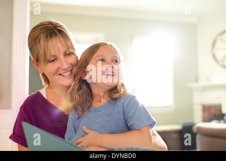 Mère et fille dans le salon de lecture Banque D'Images