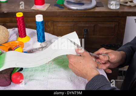 Couper des bandes de Artisan cuir à faire des boules de jai alai Banque D'Images