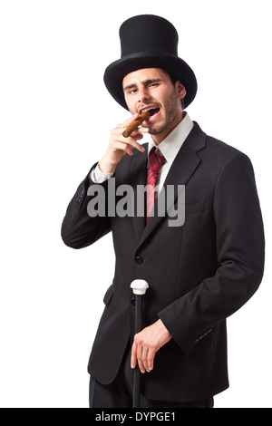 Un riche homme d'affaires avec un cigare, porter un grand chapeau et portant un bâton de marche Banque D'Images