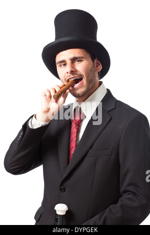 Un riche homme d'affaires avec un cigare, porter un grand chapeau et portant un bâton de marche Banque D'Images