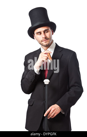 Un riche homme d'affaires avec un cigare, porter un grand chapeau et portant un bâton de marche Banque D'Images