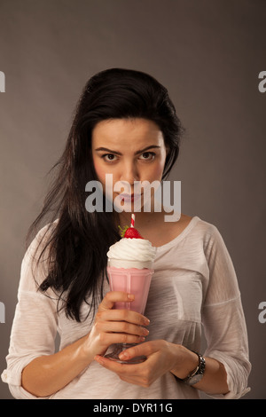 Caucasian girl avec milk shake et apple, faire des choix santé Banque D'Images