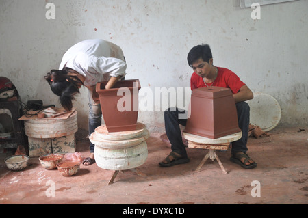 Deux potiers travailler sur des pots de céramique au village de poterie Bat Trang près de Hanoi, Vietnam Banque D'Images