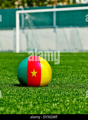 Ballon de soccer avec drapeau Cameroun sur l'herbe dans le stade Banque D'Images