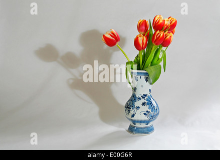 Le rouge et jaune tulipes hollandaises dans un néerlandais Delft bleu et blanc Chine vase Banque D'Images