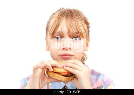 Petite fille blonde mange hamburger. Portrait isolated on white Banque D'Images