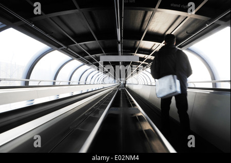 Personne sur trottoir roulant dans un ovale tunnel reliant les salles d'exposition sur le champ de foire de Düsseldorf, Allemagne Banque D'Images