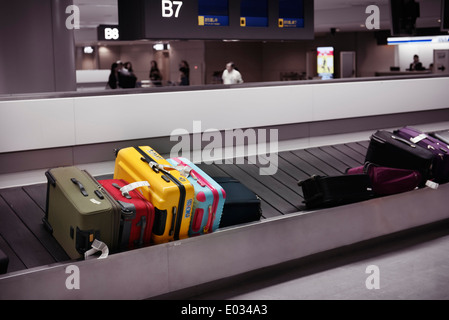 Valises colorées sur la récupération des bagages de l'aéroport carrousel convoyeur, l'Aéroport International de Narita, Japon Banque D'Images