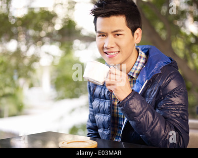 Young man drinking coffee Banque D'Images