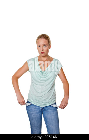 Une jeune femme montre la presse à vide poches de son jean. Photo symbolique pour dettes., eine junge Frau zeigt die leeren Hosentas Banque D'Images