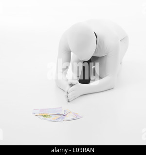 Homme vêtu de blanc avec black tie prie pour l'argent, debout sur ses genoux, sur fond blanc Banque D'Images