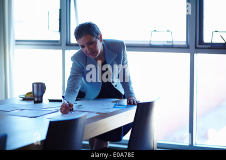 Femme mature au tableau de conférence documents de contrôle Banque D'Images