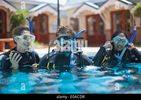 Trois jeunes plongeurs adultes en formation piscine Banque D'Images