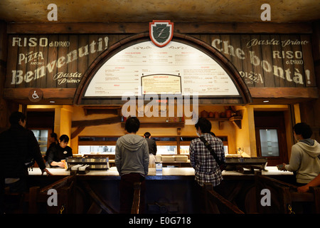 Les gens à l'alimentation de commande Zambini Brothers Ristorante, restaurant italien à Tokyo Disneysea, au Japon. Banque D'Images