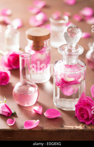 L'alchimie et l'aromathérapie avec des fleurs rose et flacons Banque D'Images