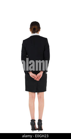 Man in suit standing with hands behind back Banque D'Images