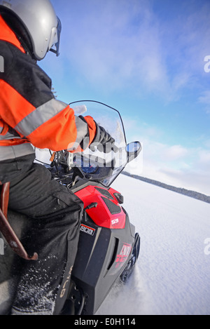 Antti, jeune guide finlandais de visitinari, conduit une motoneige dans le désert d'Inari, Finlande Banque D'Images