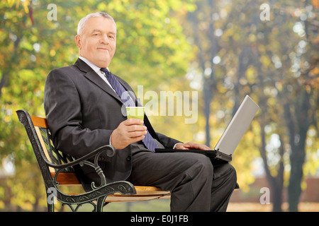 Mature businessman Taking a break assis sur un banc dans le parc Banque D'Images