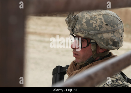 Un soldat de l'armée américaine est à l'écoute les ordres de son chef de section lors d'une mission dans le village d'Calenday Jaghato, District, Wa Banque D'Images