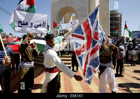 Gaza, Territoires palestiniens. 15 mai, 2014. Un palestiniens brûlent des répliques des drapeaux israéliens et britanniques au cours d'un rassemblement d'avance sur le 66e anniversaire de la Nakba, à Rafah dans le sud de la bande de Gaza le 14 mai 2014. Marque ''palestiniens'' de la Nakba (catastrophe) le 15 mai pour commémorer l'expulsion ou la fuite de quelque 700 000 Palestiniens de leurs maisons dans la guerre qui a mené à la fondation d'Israël en 1948. © Abed Rahim Khatib/NurPhoto ZUMAPRESS.com/Alamy/Live News Banque D'Images