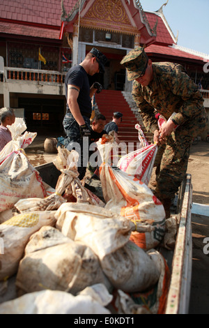 Lance le Cpl. Christopher J. Brown, opérateur de satellite, III Marine Expeditionary Force Flood Relief Élément de commandement, sacs charges fu Banque D'Images