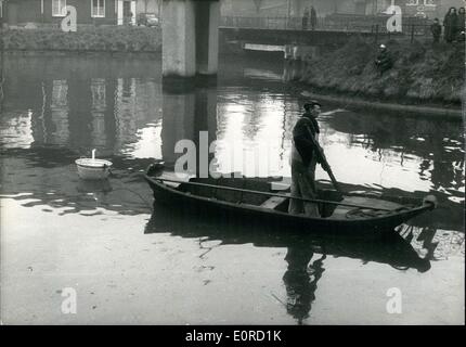 10 févr. 02, 1959 - Bargeman ressuscitant coutume : Lille bargeman fait revivre une vieille coutume des siècles lors de la recherche pour le corps d'une petite fille qui s'est noyé dans un canal hier. selon la coutume une bougie allumée placée dans un bassin de métal est remorqué par le chaland. La flamme commence à clignoter et s'éteint lorsque le chaland passe au-dessus d'un corps d'un noyé, homme ou femme. Photo montre la Barge man le remorquage de la bougie allumée sur le canal. Banque D'Images