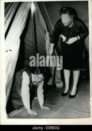 10 févr. 02, 1959 - La Princesse Marijk aspects sa tente don. 12e. Anniversaire . : une délégation de la communications des troupes de l'Armée royale néerlandaise s'est rendu hier à Soestdijk Palace, de présenter une 12e. anniversaire cadeau à la Princesse Marijke, qui était un double-toit tente. La photo montre la Princesse Marijke se traîne hors de la tente, qui était placé dans l'une des chambres du palais, après l'inspection de ce que sa mère, la reine Juliana des Pays-Bas, les regarde. Banque D'Images