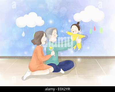 Un vieux couple jouant avec un bébé Banque D'Images