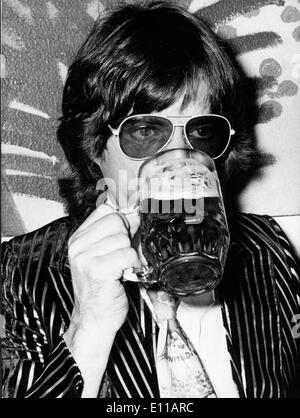 Le chanteur des Rolling Stones Mick Jagger boit une bière Banque D'Images