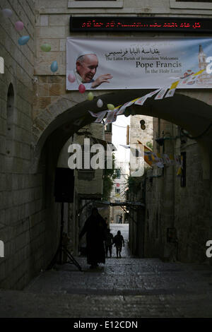 Jérusalem, Jérusalem, territoire palestinien. 21 mai, 2014. Un chrétien palestinien igoogle une bannière représentant le Pape François dans la vieille ville de Jérusalem le 21 mai 2014, quelques jours avant la visite de haut niveau par le Pape François en Terre Sainte. Le Pape visitera Gethsémané pendant son premier voyage dans la région, visiter la Jordanie, les territoires palestiniens et en Israël du 24 mai au 26 mai Crédit : Saeed Qaq/APA Images/ZUMAPRESS.com/Alamy Live News Banque D'Images