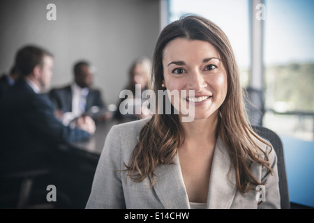 Businesswoman smiling in conference room Banque D'Images