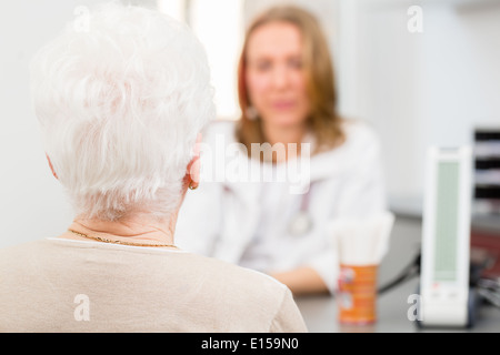 Jeune femme médecin retraité assis avec consultation de chirurgie en heure à 24 Banque D'Images