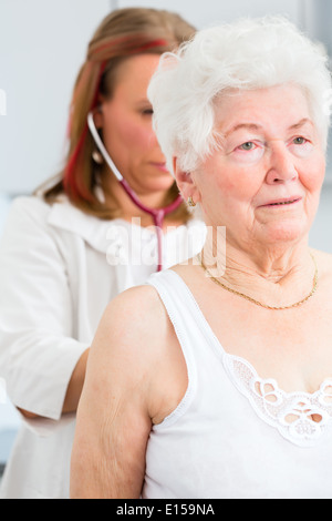 Femme médecin et poumons de respiration ausculter pensionné avec stéthoscope en chirurgie Banque D'Images