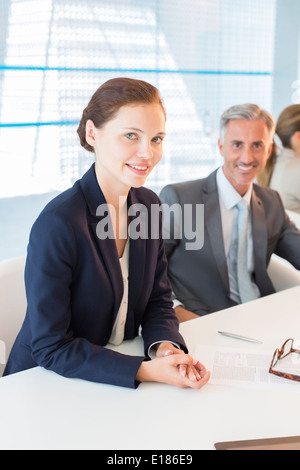 Portrait of business people at conference table Banque D'Images