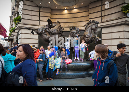 Les touristes autour des quatre chevaux de bronze de Helios sculpture sur Piccadilly Londres Banque D'Images