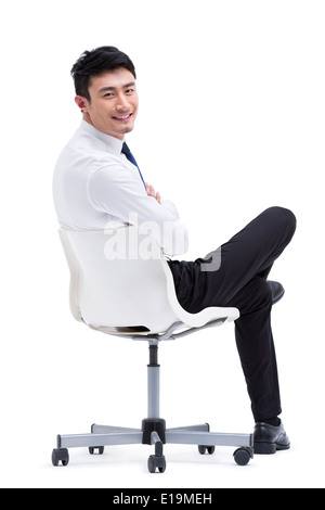 Certain young businessman sitting on chair Banque D'Images