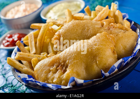 La Golden delicious batter le poisson frit avec des frites, sauce tartare, salade de chou, et du ketchup. Banque D'Images