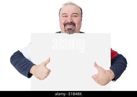 Happy smiling middle-aged man avec une barbiche holding a blank tableau blanc avec copyspace pour votre texte donnant un geste Thumbs up Banque D'Images