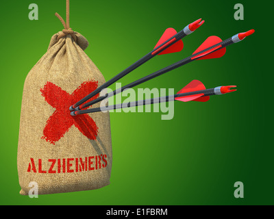 Alzheimers - trois flèches Hit en marque rouge sur cible un sac suspendu sur fond vert. Banque D'Images