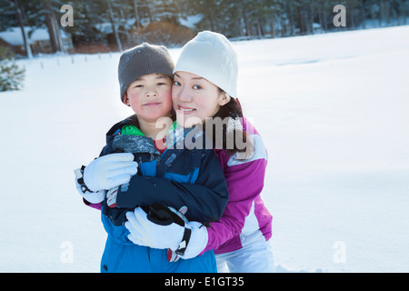 Famille heureuse sur la masse de neige Banque D'Images
