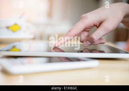 Close up of young woman's hand using touchscreen sur tablette numérique Banque D'Images