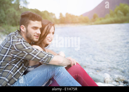 Jeune couple gazing sur Toce riverbank, Piemonte, Italie Banque D'Images